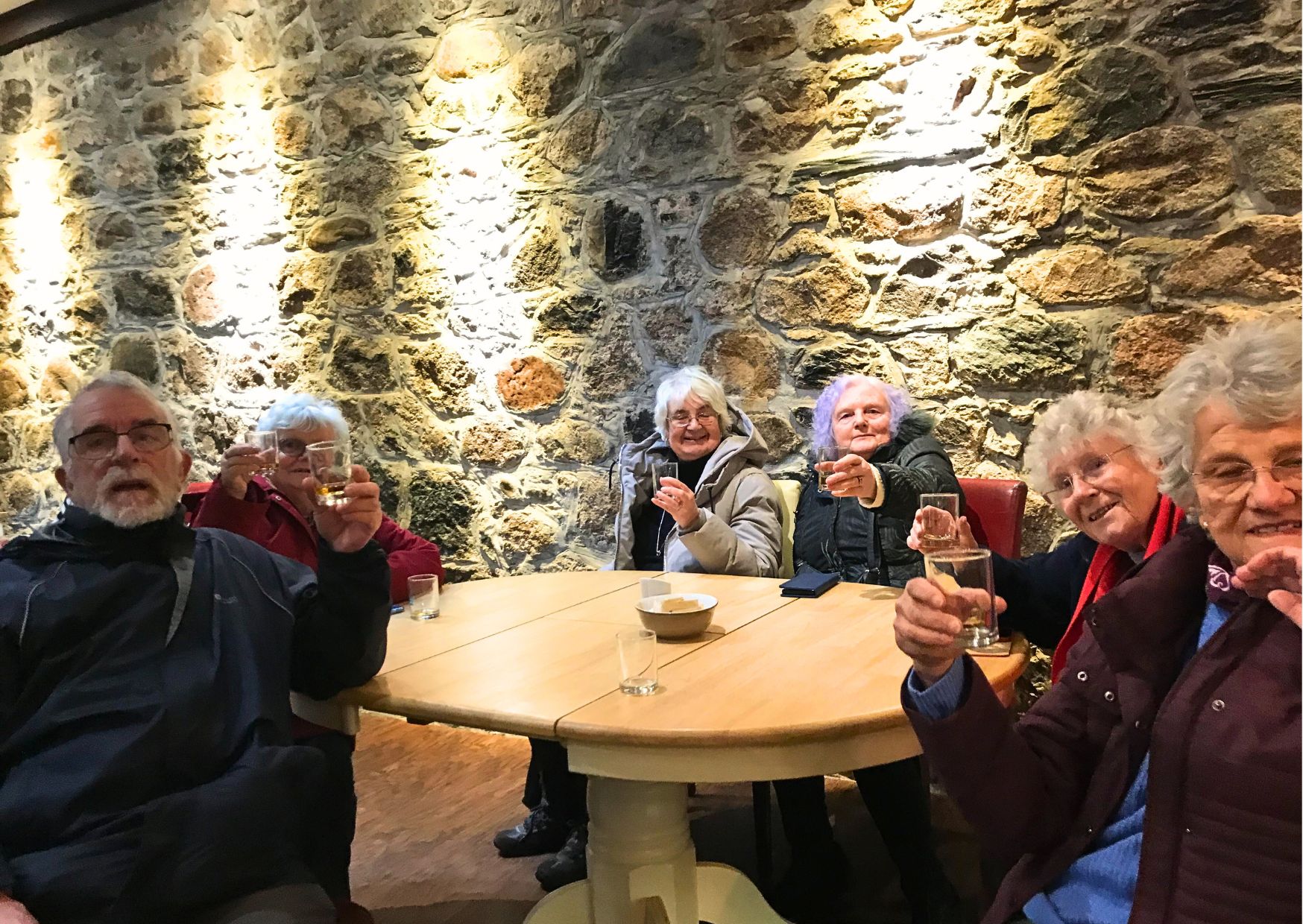 Members enjoying a wee dram at the end of a busy day of siteseeing in their Highland Holiday.